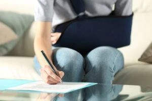 An injured woman fills out forms for her Chicago hit and run accident lawyer.