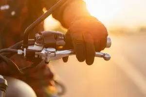 motorcycle rider holds handlebars in Edwardsville sunset