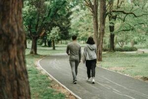 Two pedestrians walk down a protected lane together.