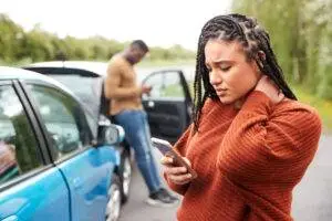A woman in a rideshare accident calls a St. Louis rideshare accident lawyer.
