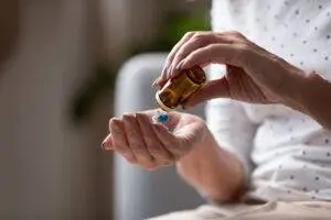 Old woman empties defective bottle of pills