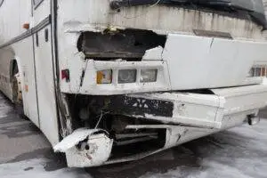 A bus with damage to the front end.