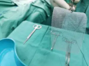 A doctor holding surgical mesh. You can get damages with help from a Belleville defective medical device lawyer.