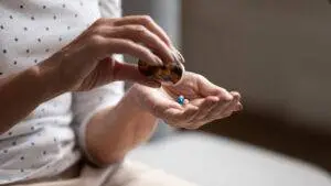 A woman taking medication. Discuss your legal options today with a Carbondale defective drug lawyer.