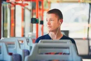 A worried man on a bus. Find out if you can sue the bus company or if just the driver is liable after an accident. 