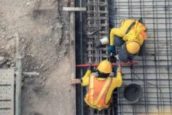 Two men working construction. Go over types of construction accidents a lawyer can assist with by contacting us.