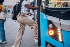 A woman getting on a bus. Find out if you can settle a bus accident case out of court.