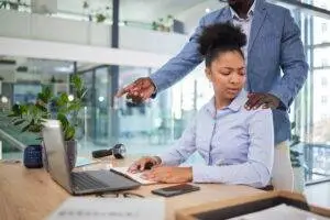 A woman facing workplace harassment. You can discuss your situation with a Belleville sexual harassment lawyer.