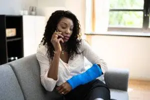 An injured woman calls a Chicago slip and fall injury lawyer.