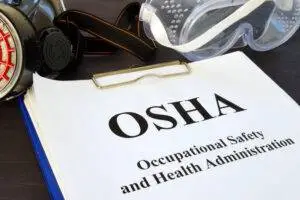 A folder of OSHA paperwork. Review the role of OSHA in construction accident cases with our team.