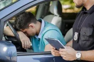 A man realizing how much trouble he’s in after aggressive driving. Hire a Bronx aggressive driving accident attorney if you’ve been hit.