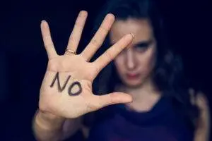 A woman with the word no written on her outstretched hand symbolizes telling her abuser to stop and that she has legal protection from a sexual abuse attorney in North Bergen.