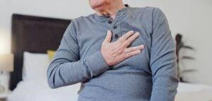 A man with a hypoxia injury puts his hand over his chest.