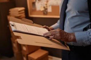 A police officer holds a paper folder with a police report. This accident report was filed within 10 days of the collision, before New Jersey’s deadline.