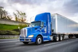 A large truck driving down the highway. Build a legal claim for compensation with a Riverside truck accident lawyer.