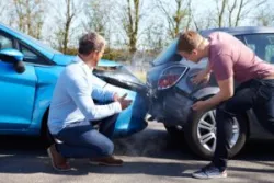 Men talking after an accident. Discuss building a legal claim now with a Riverside car accident lawyer.