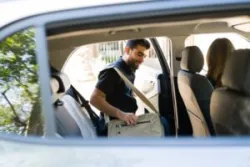 A man getting into a rideshare vehicle. After a collision, you can turn to a Bakersfield rideshare accident lawyer.