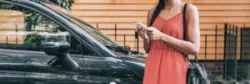 A woman waiting for a rideshare vehicle. A Long Beach rideshare accident lawyer can help you after a collision.