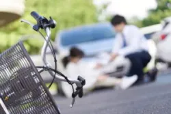 A male driver helps a female bicycle rider get up after an accident. A bicycle accident lawyer in San Francisco will help you build an evidence-based case.