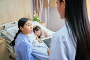 A concerned mother with her child in a hospital. A lawyer can explain if you can claim compensation for your child after an accident.