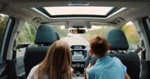 Two children in the backseat of a car. A lawyer can explain what happens if children are involved in a car accident.