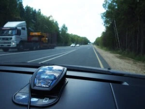 Radar detector mounted on car dashboard. Are Radar Detectors Legal in California?