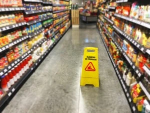 Wet floor sign in a store aisle. Can I sue if I slip and fall at Target?