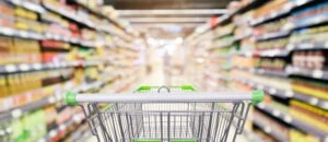 Grocery store aisle with shopping cart. How much money does Walmart settle for slip and fall accidents?