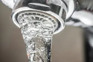 close-up on tap water running from faucet
