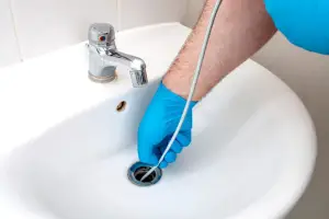 plumber snaking drain