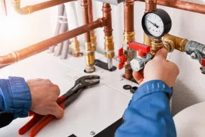 plumber adjusting water pipes