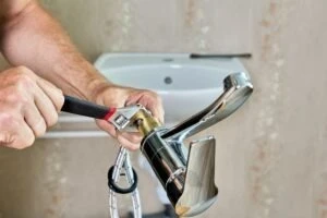 A plumber in Arizona working on pipes.