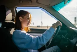 woman behind the wheel driving her car