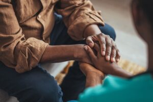 woman-holds-man-hand-comforting-after-wrongful-death