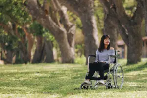 young-woman-sitting-wheelchair-park