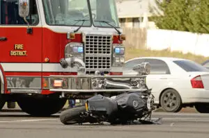 motorcycle crushed by a fire truck