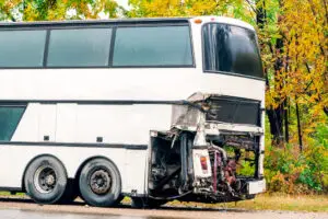 white bus with damage after crash