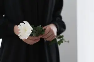 woman holding white chrysanthemum