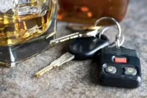 Car keys and a glass of alcohol symbolizing DUI cases