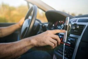 Distracted driver holding a phone while driving