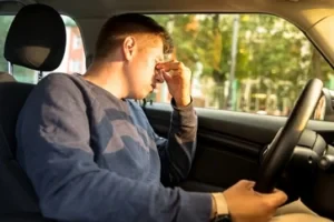 Tired driver behind the wheel, symbolizing drowsy driving