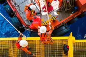 Offshore oil rig workers abandon a rig after a natural disaster.