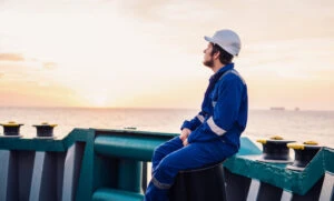 A young man on an offshore vessel wondering, “What is the average maritime injury settlement?”