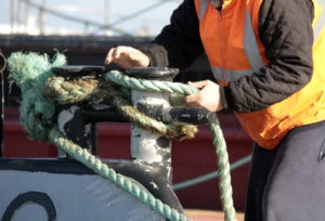 A deckhand working on a boat. A lawyer can explain what a deckhand should do following a work injury.