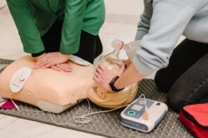 EMTs using an AED on a test dummy. Do businesses have a duty to maintain AEDs.