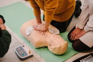 EMTs using an AED on a test dummy. What happens if an AED was present but not used in time?