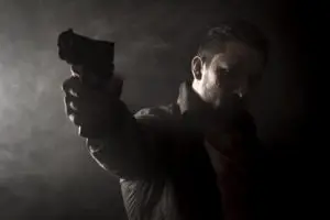 man in shadow with a gun