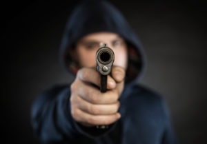 man pointing a gun at the camera