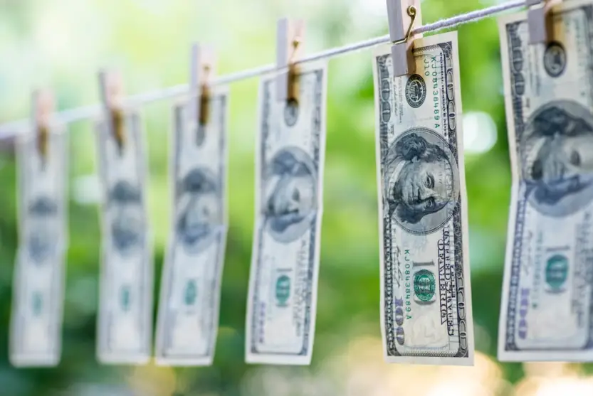 hundred-dollar bills hanging on clothesline 