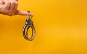 pair of handcuffs dangling from finger